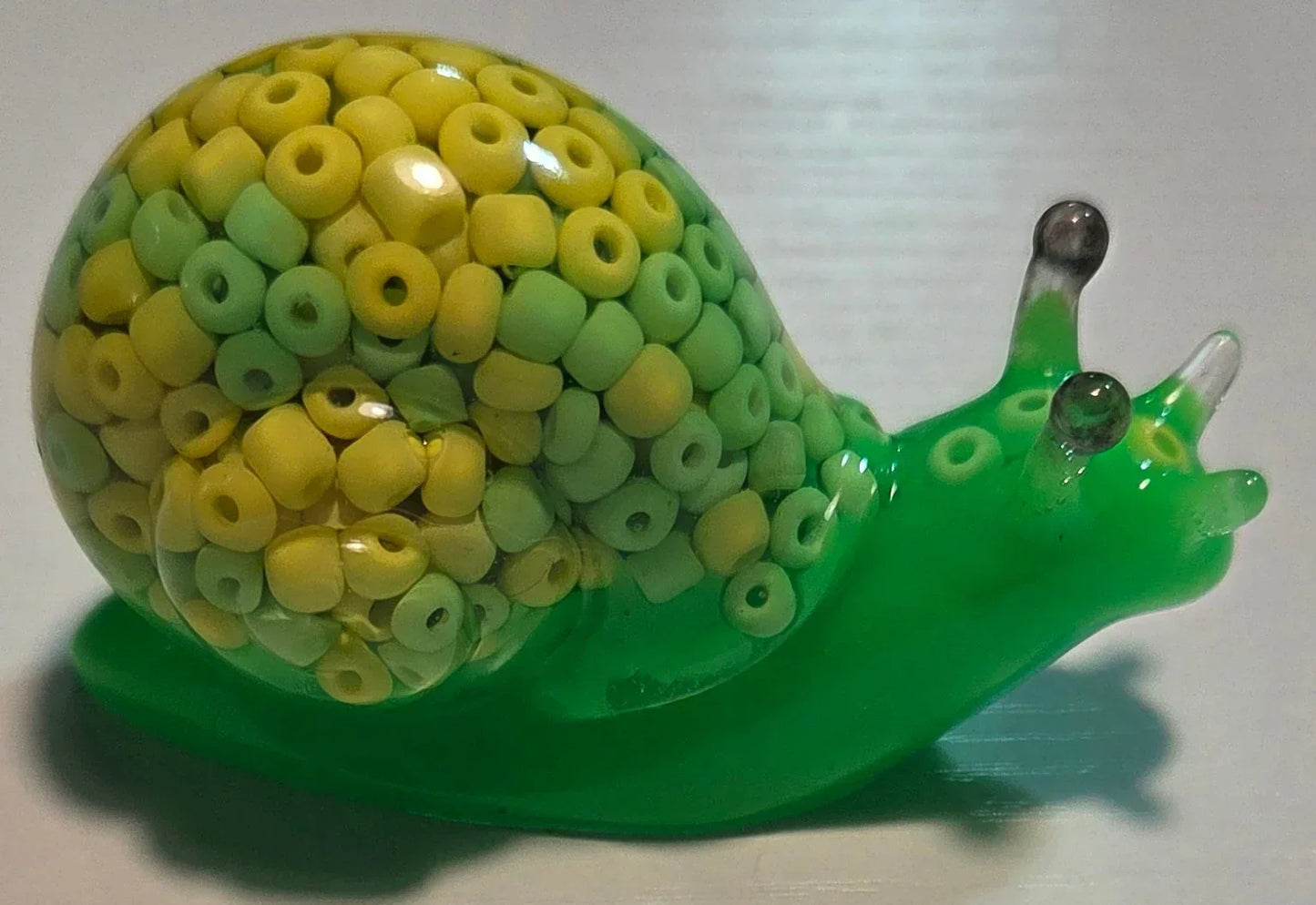 **Handcrafted Key Lime Beaded Resin Snail Figurine - Vibrant Green Maximalist Decor | Whimsical Artisan Desk Companion by Crazy Chaotic Crafter**