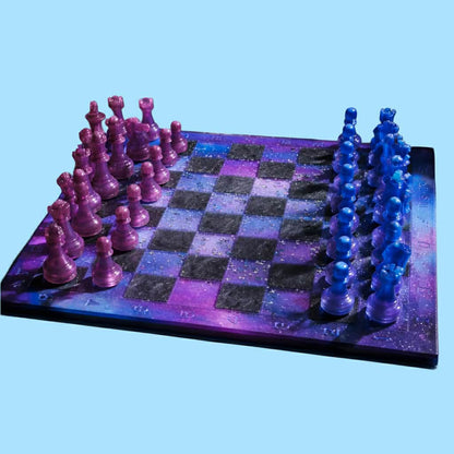 Handcrafted cosmic purple and blue galaxy resin chess set with holographic glitter pieces by Crazy Chaotic Crafter.