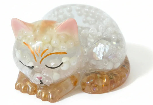 Handcrafted sleeping cat resin figurine filled with white iridescent pearls and amber translucent accents by Crazy Chaotic Crafter